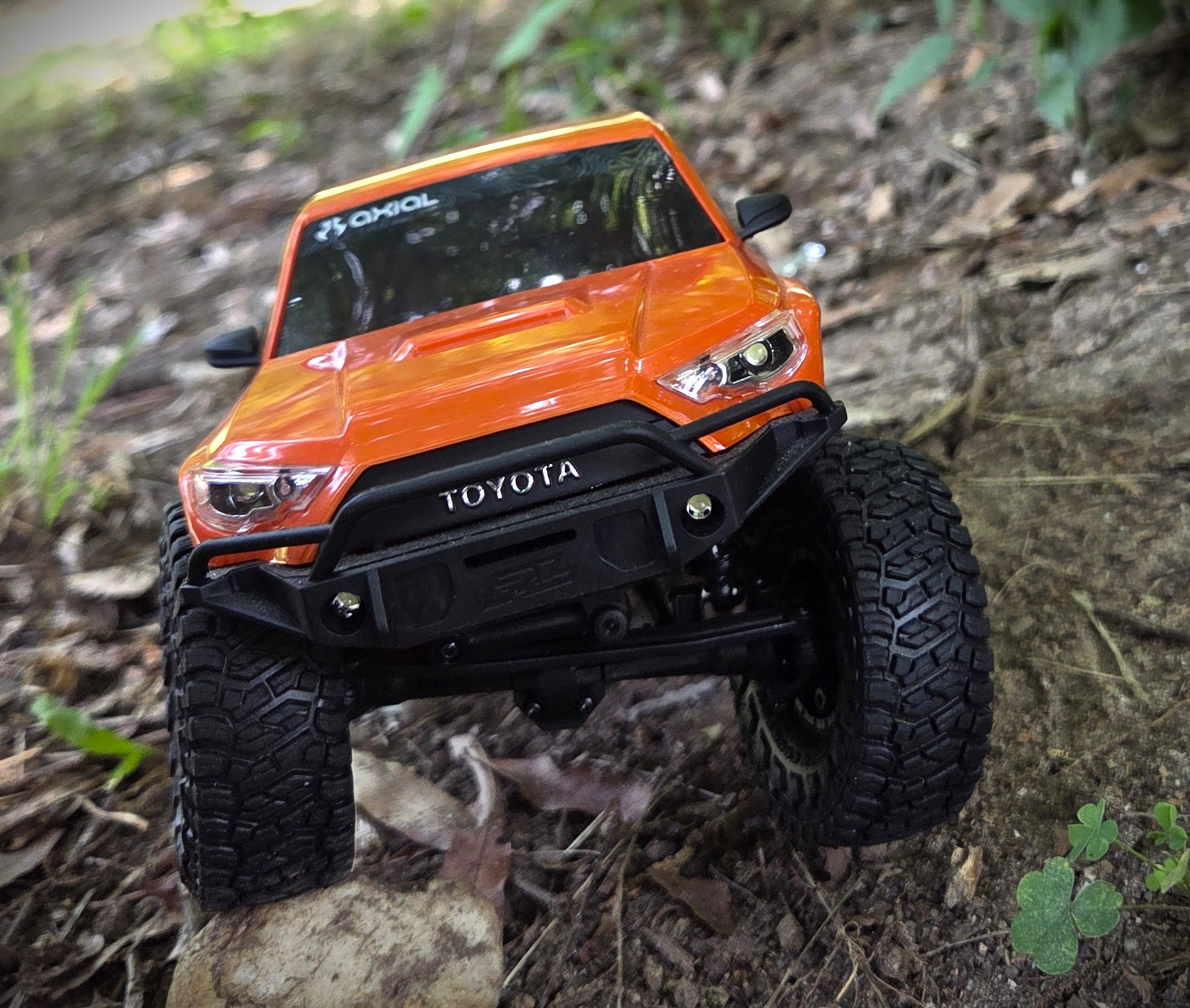 Top-down aerial view of orange Axial SCX24 Toyota 4Runner showing roof detail and Axial branding